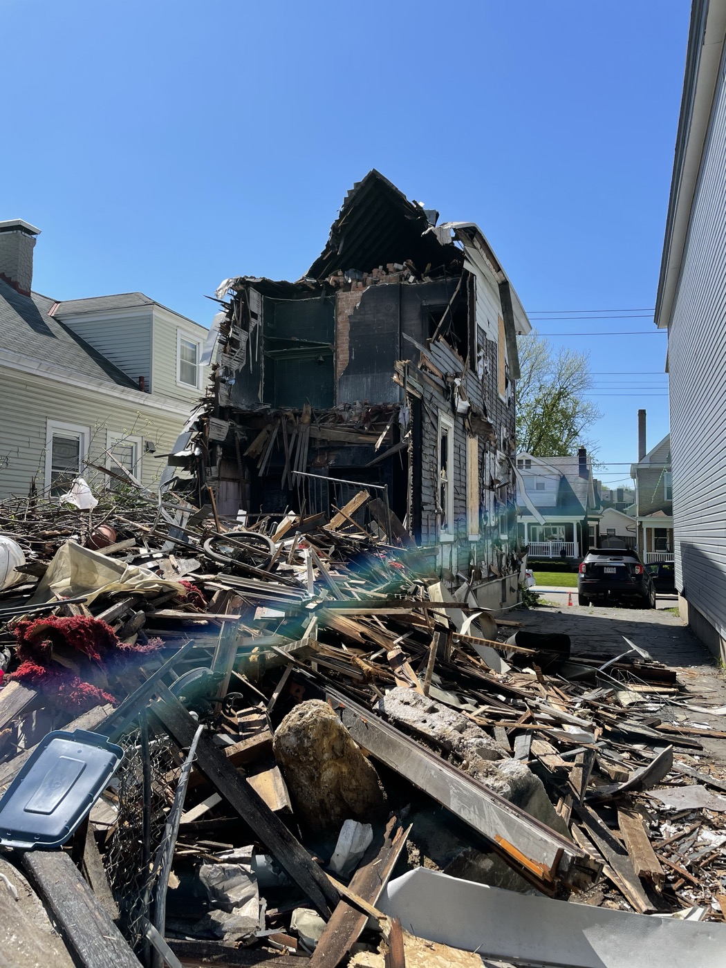 An old house torn down to a pile of lumber and debris