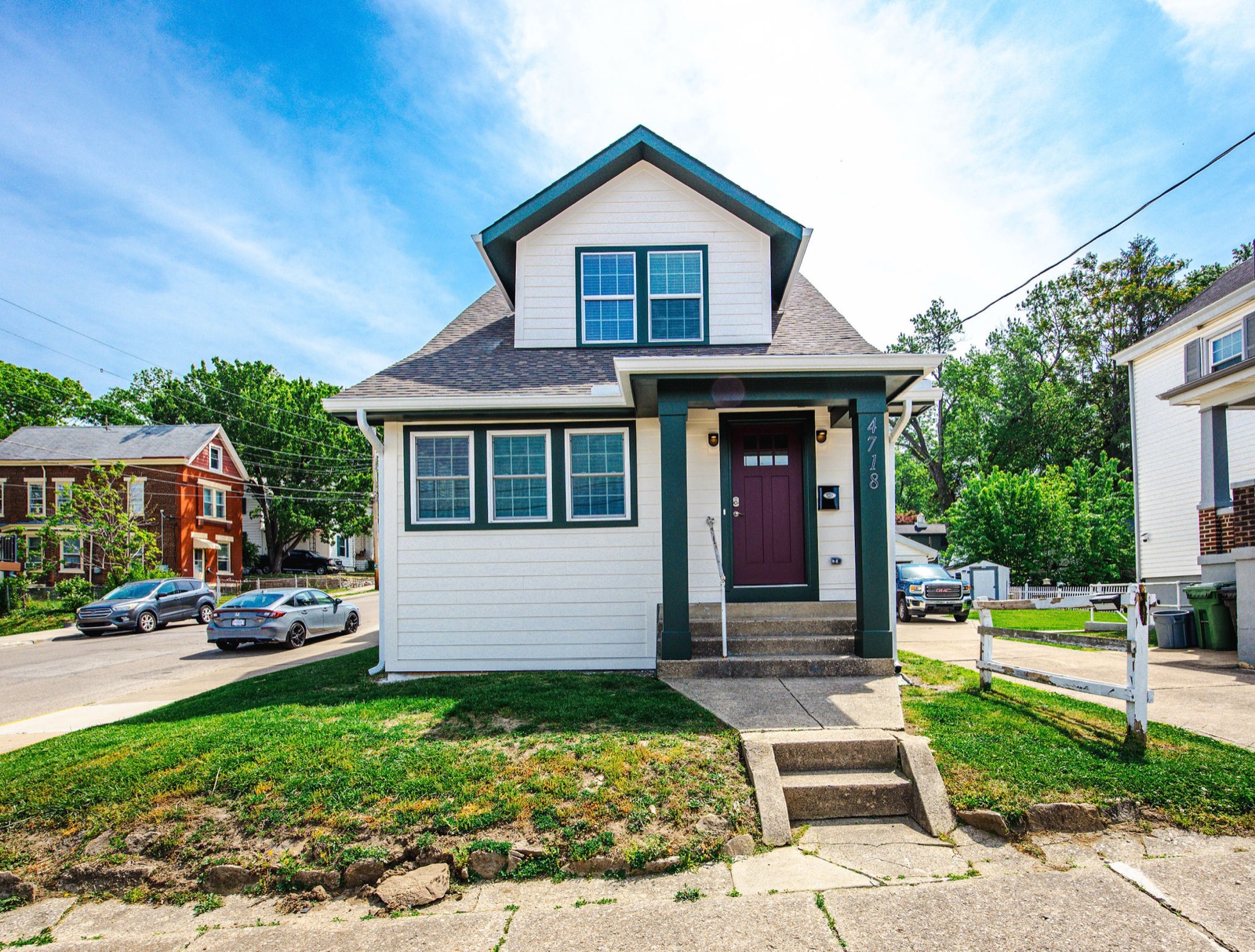 A finished white two-story house with a covered front porch