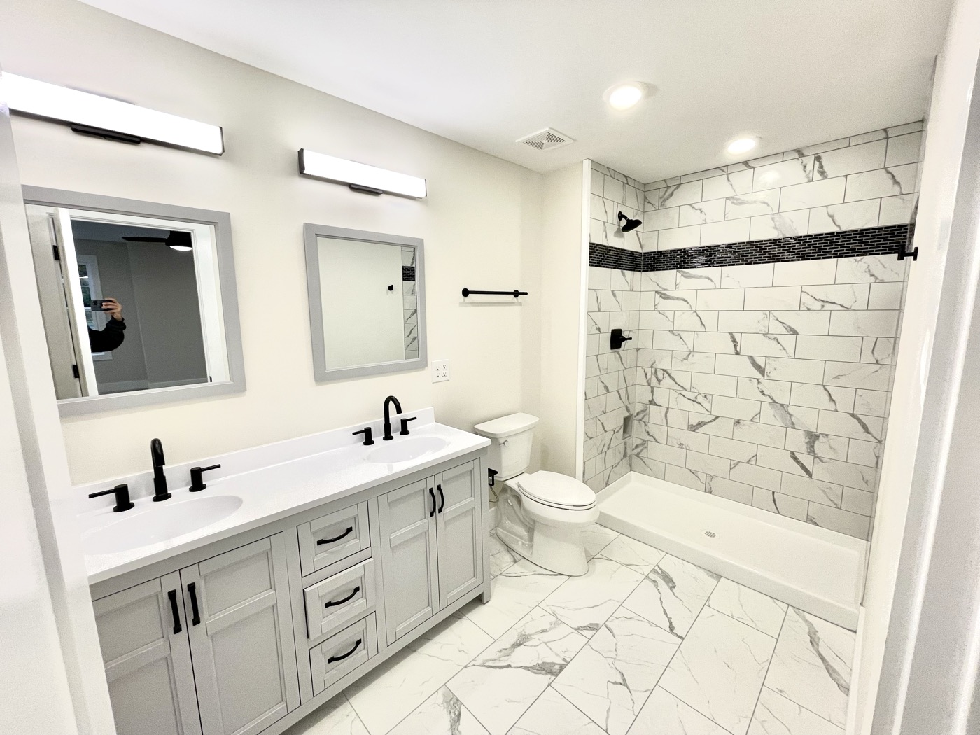 A new double vanity and marble-look tile shower