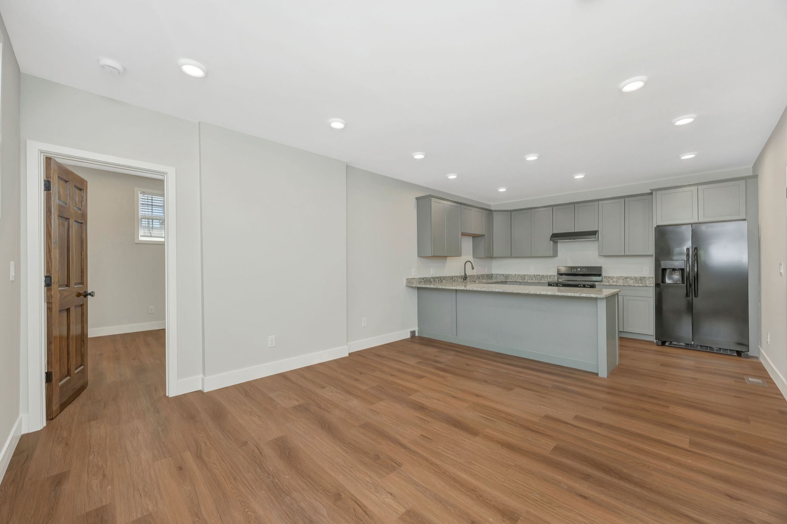An open living area leading into a renovated kitchen