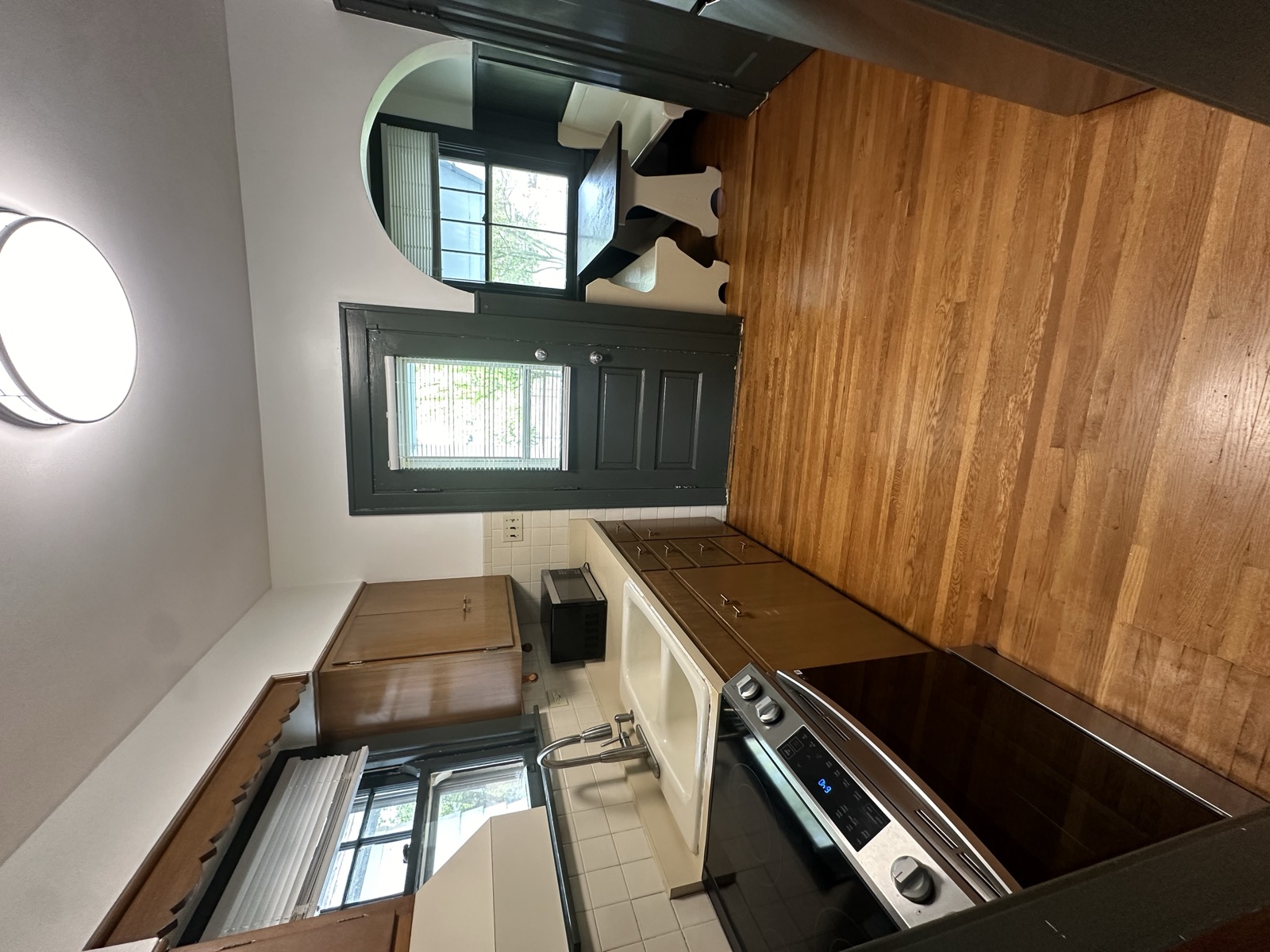 A freshly painted apartment kitchen with wood floors
