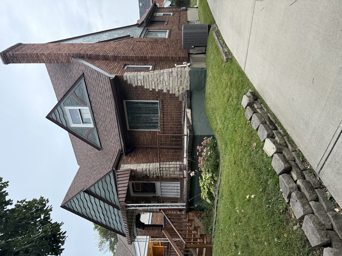 Side view of a brick bungalow with repainted gables and trim