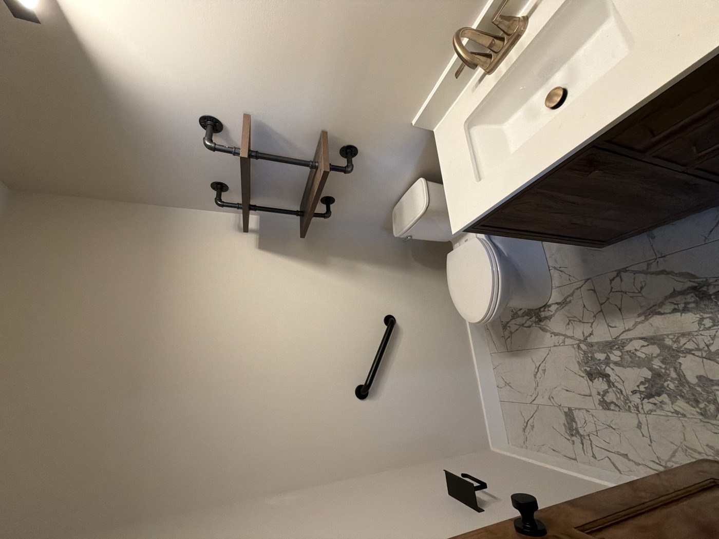 An apartment bathroom with fresh paint and a new vanity