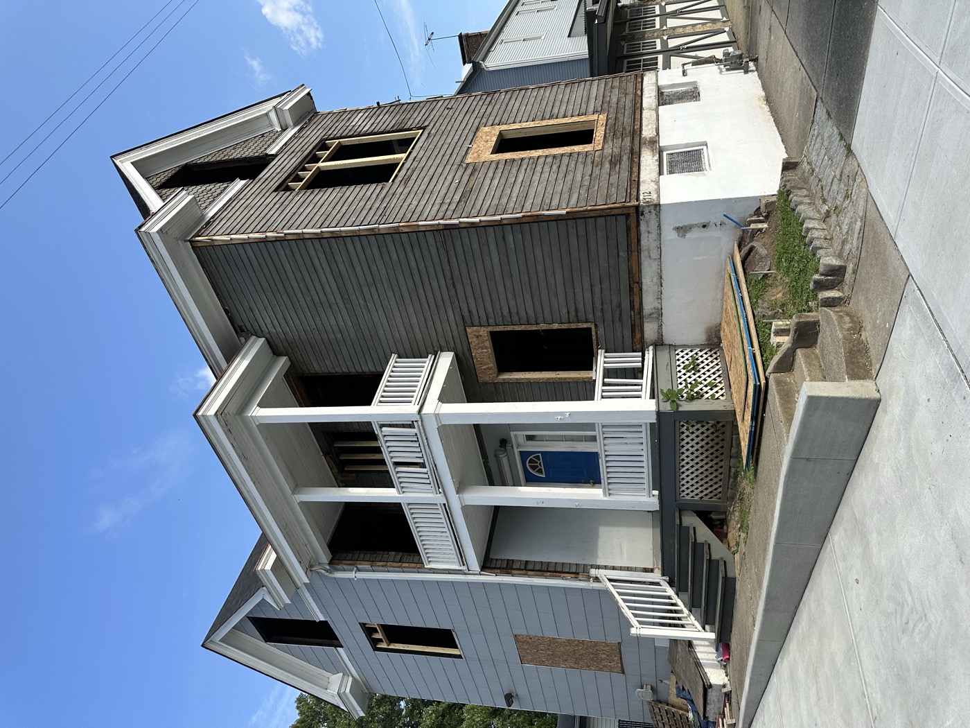 A three-story house mid-rehab with new porches going on